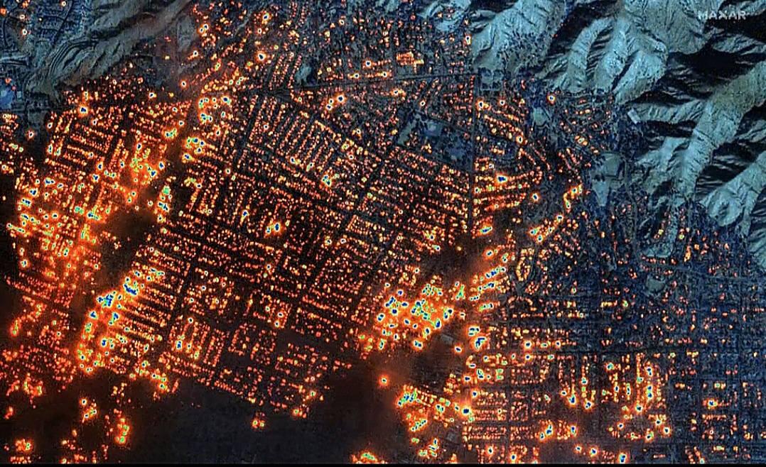 High-resolution satellite imagery from Maxar Technologies capturing widespread fire hotspots across an urban landscape, highlighting active burn zones and thermal intensity for rapid situational awareness and emergency response.